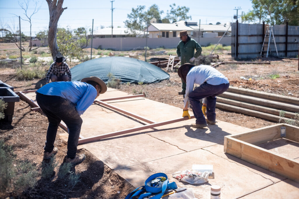 Outback links volunteers and fs staff beginning to construct garden beds on foundations cleared of debris