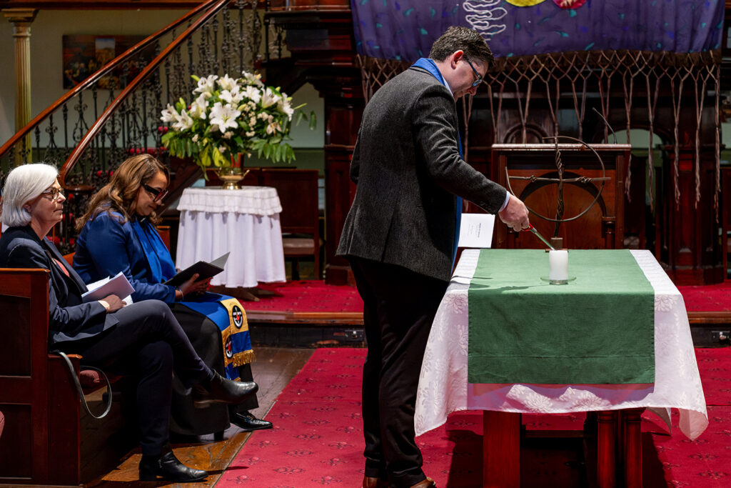 Assembly General Secretary Andrew Johnson lights the candle Assembly General Secretary Andrew Johnson lights the candle